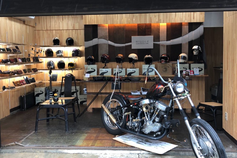 A vintage motorcycle and hand-lacquered helmets on display at Misora Urushi Craft