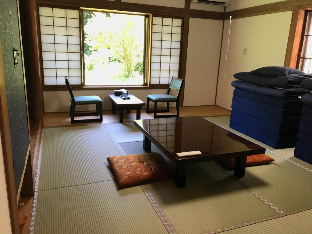 A tatami guest room with futons and a sitting area